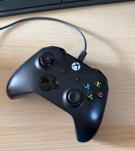 An image of an xbox controller with a cable attached.