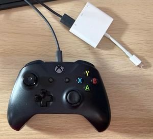 An XBox controller with a USB-A cable attached and a USB-A to USB-C adapter